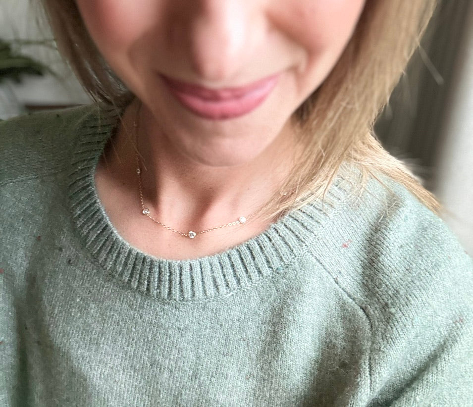 woman wearing 14K gold filled tin cup CZ necklace layered minimalist style