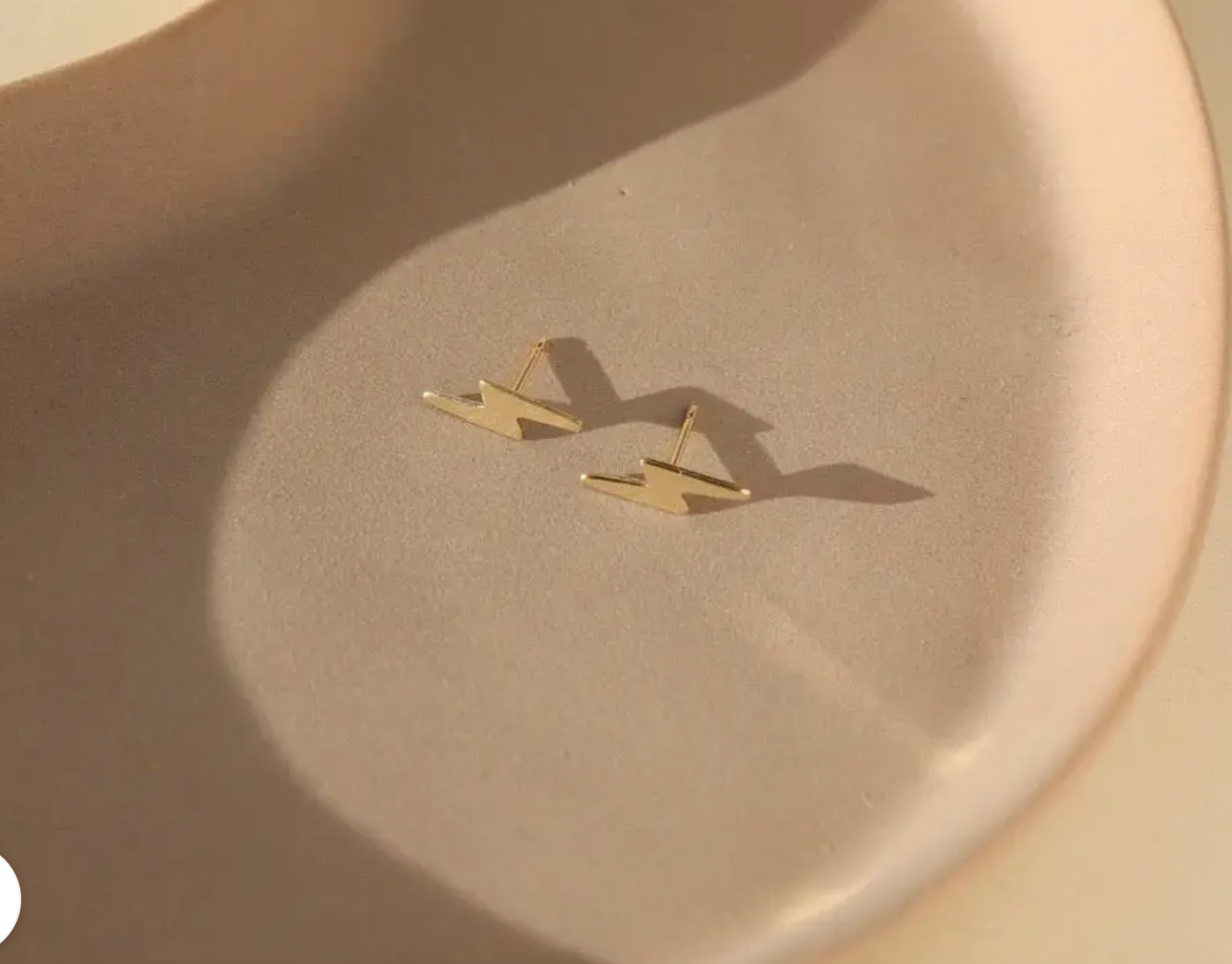 Tiny lightning bolt studs close up on neutral background