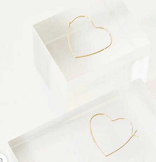Gold heart shaped hoop earrings close up detail