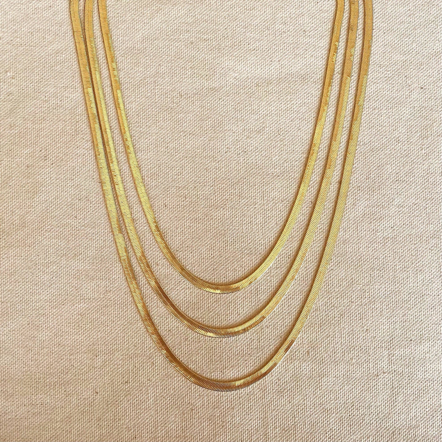 18k gold filled 4.0mm herringbone necklace on white background