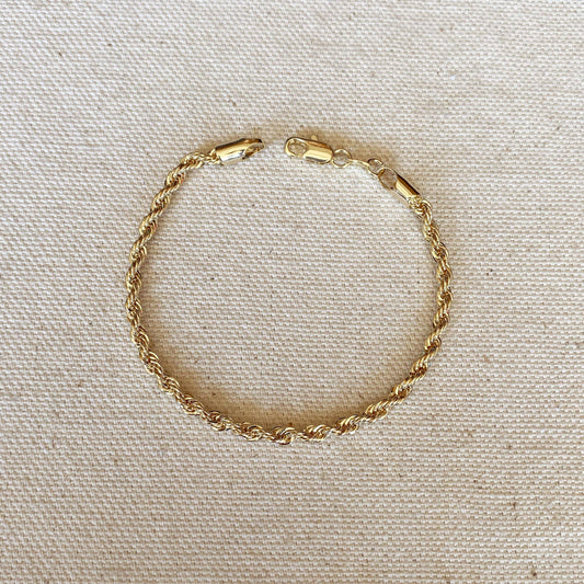 An 18k gold filled braided rope bracelet featuring a lobster clasp, shown close up.
