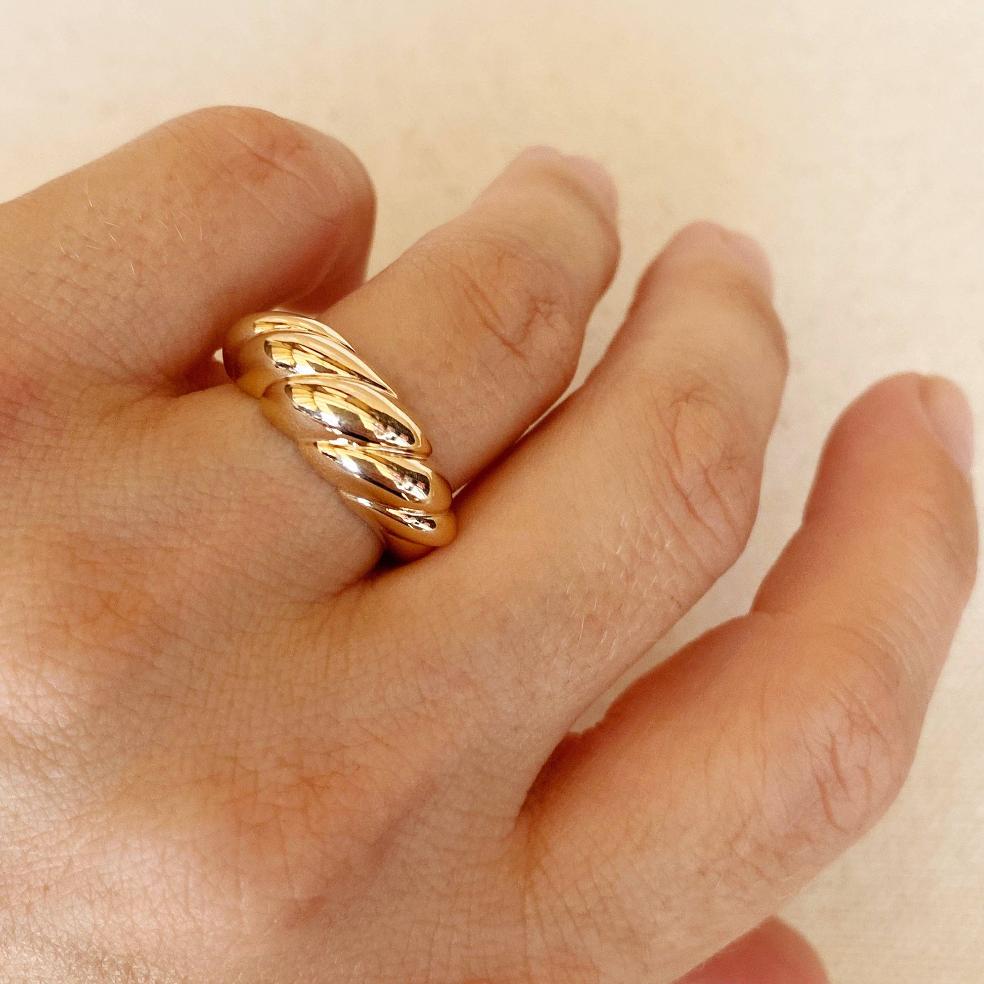 Close up of dome croissant shaped ring in gold filled on woman's hand