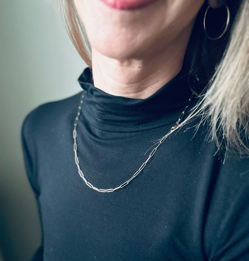 Paperclip chain necklace in gold-filled, shown on a woman's neck