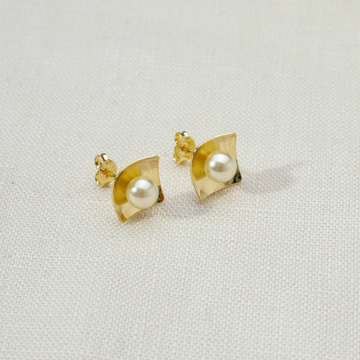 Close up of 18k gold filled pearl stud earrings that are hypoallergenic 