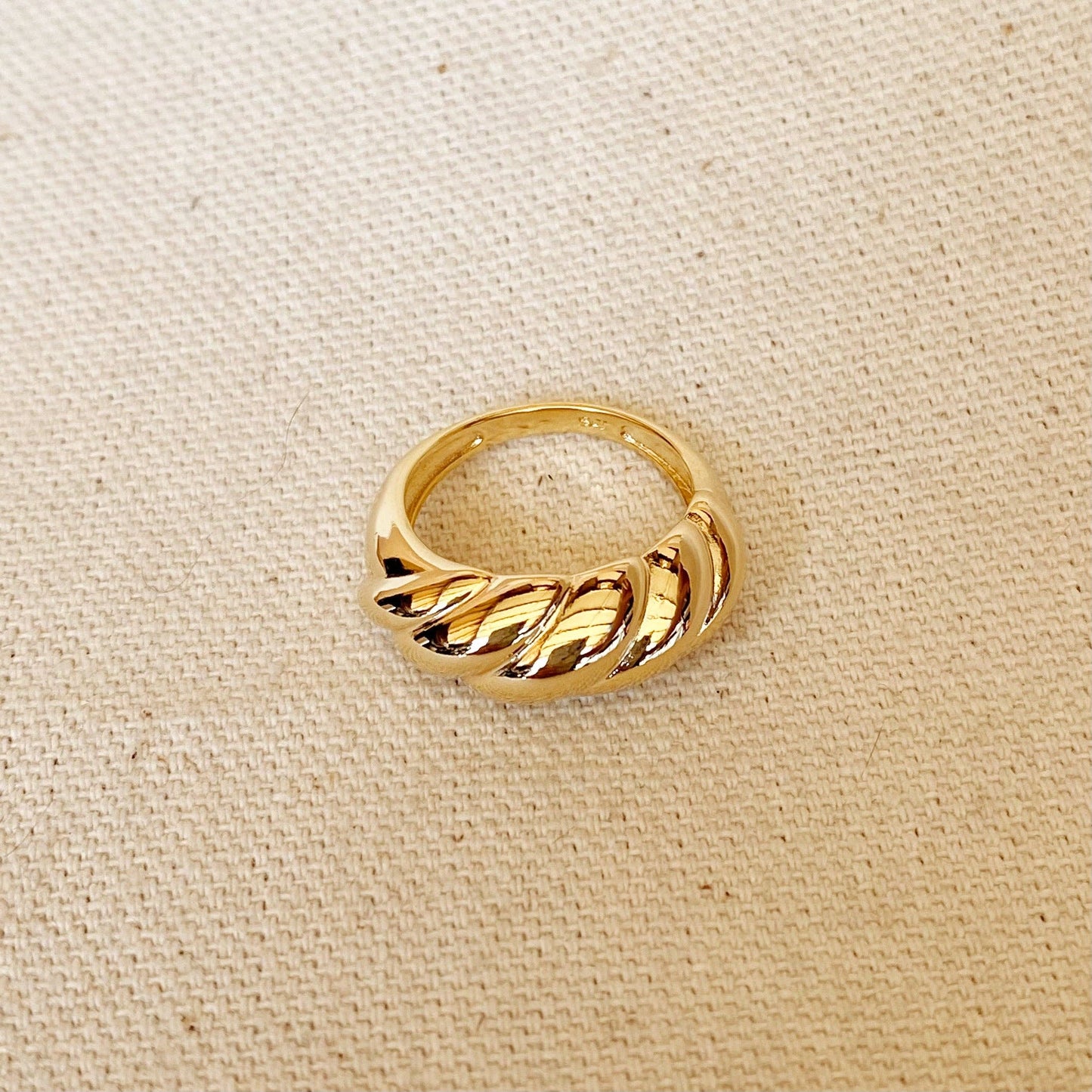 Detail dome croissant shaped ring in gold, shows shine and finish
