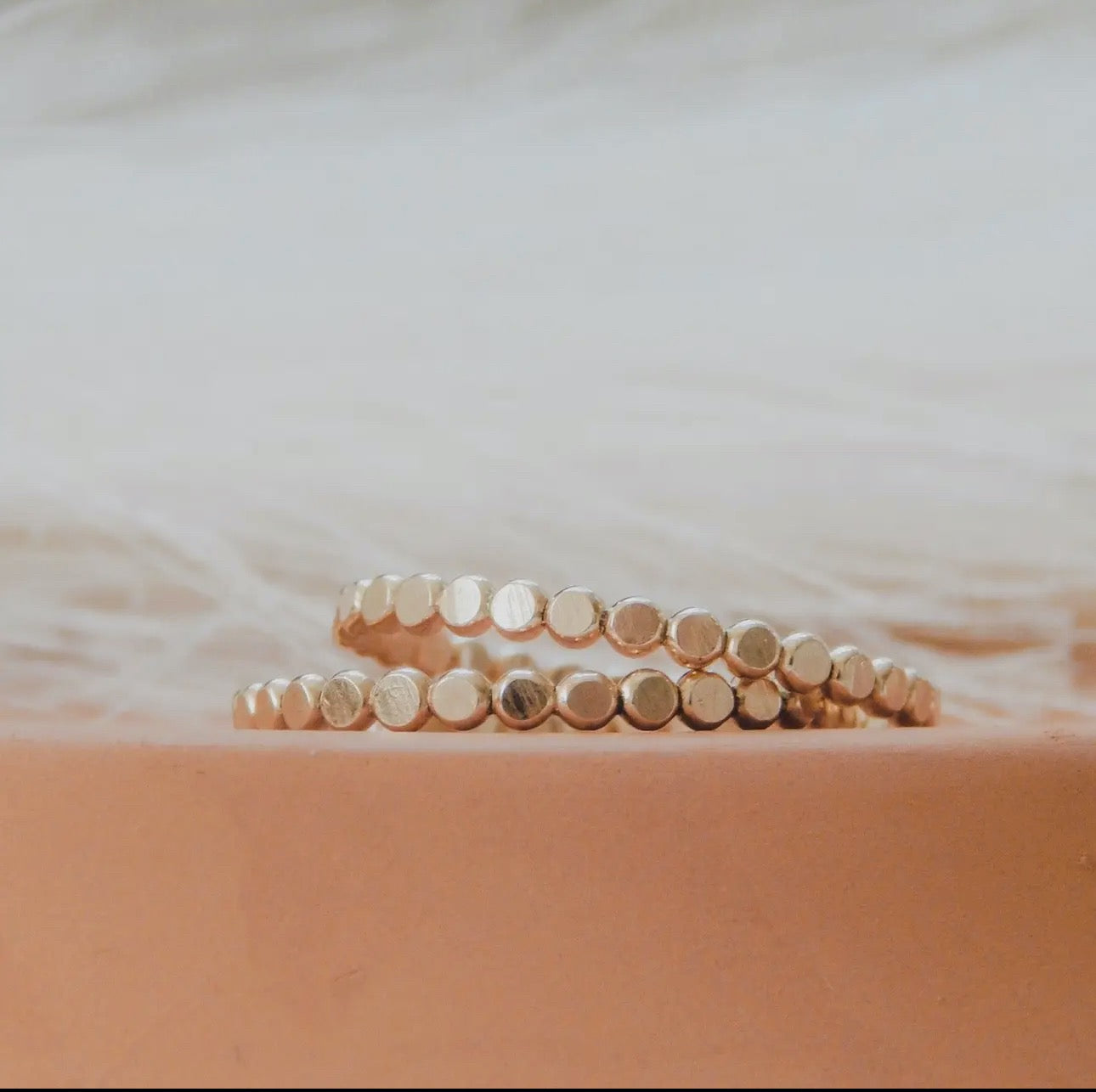 Detail shot of pebble ring with organic texture in gold filled, minimal style