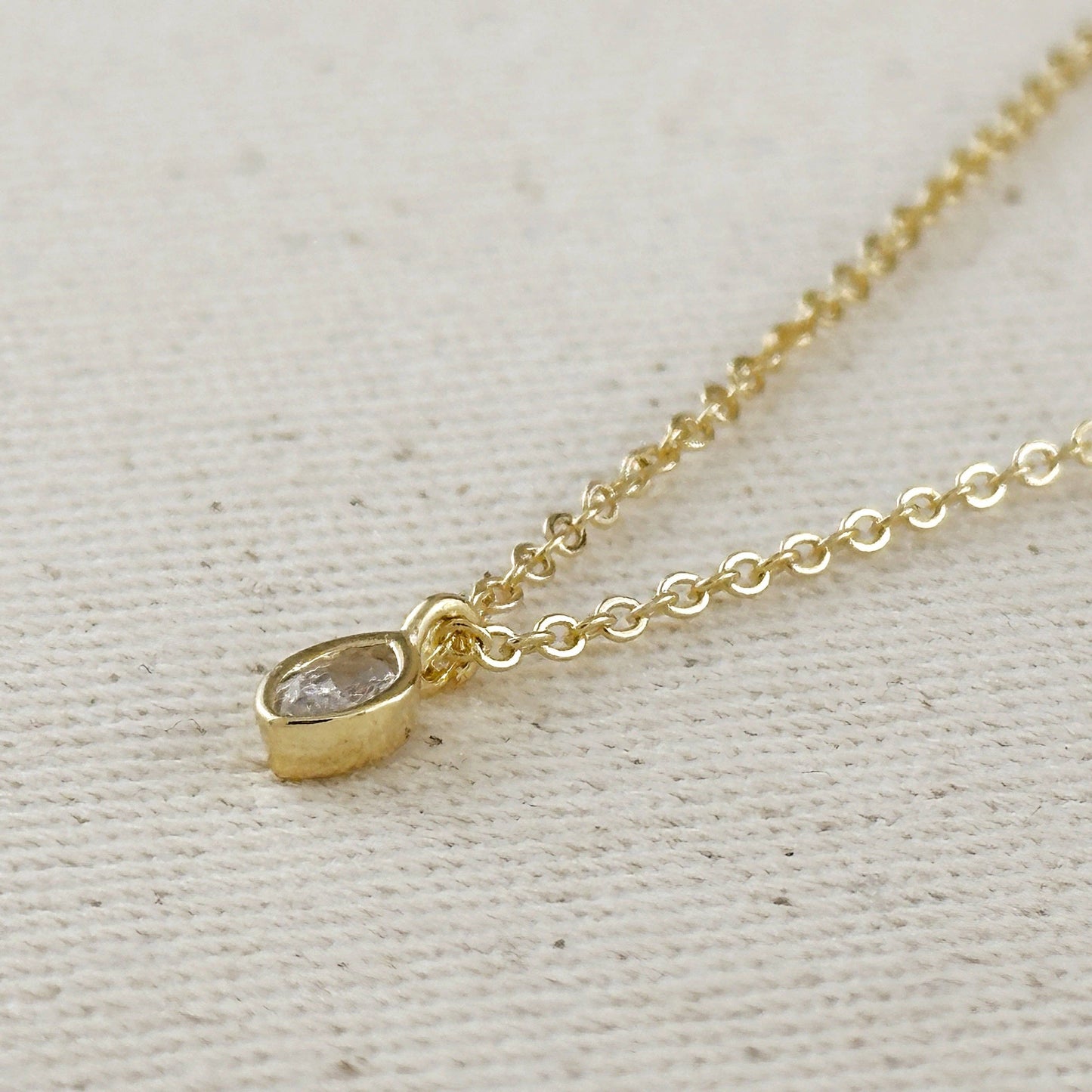 simple gold ellipse pendant necklace close up elegant design