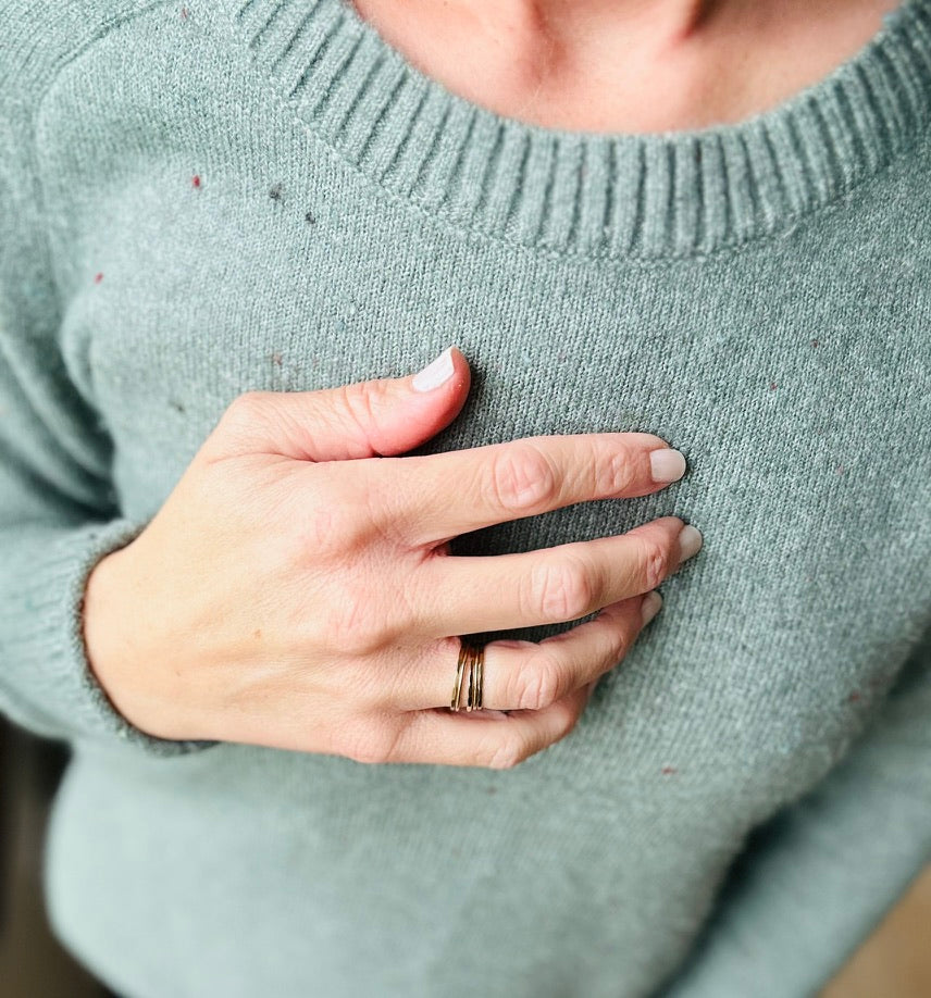 Facet ring with textured finish in gold, shown on woman's finger 