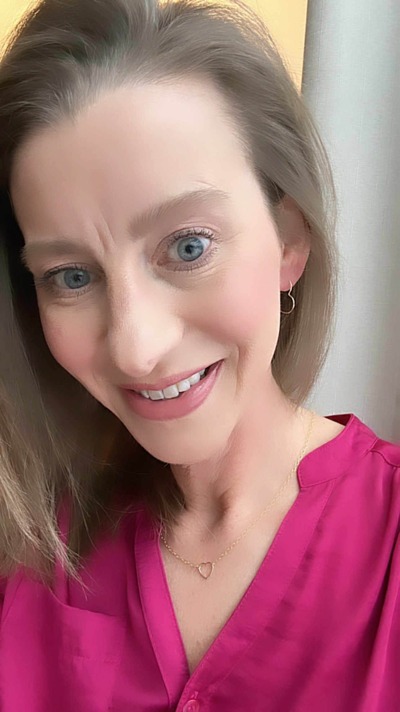 heart shaped hoop earrings on woman's ear