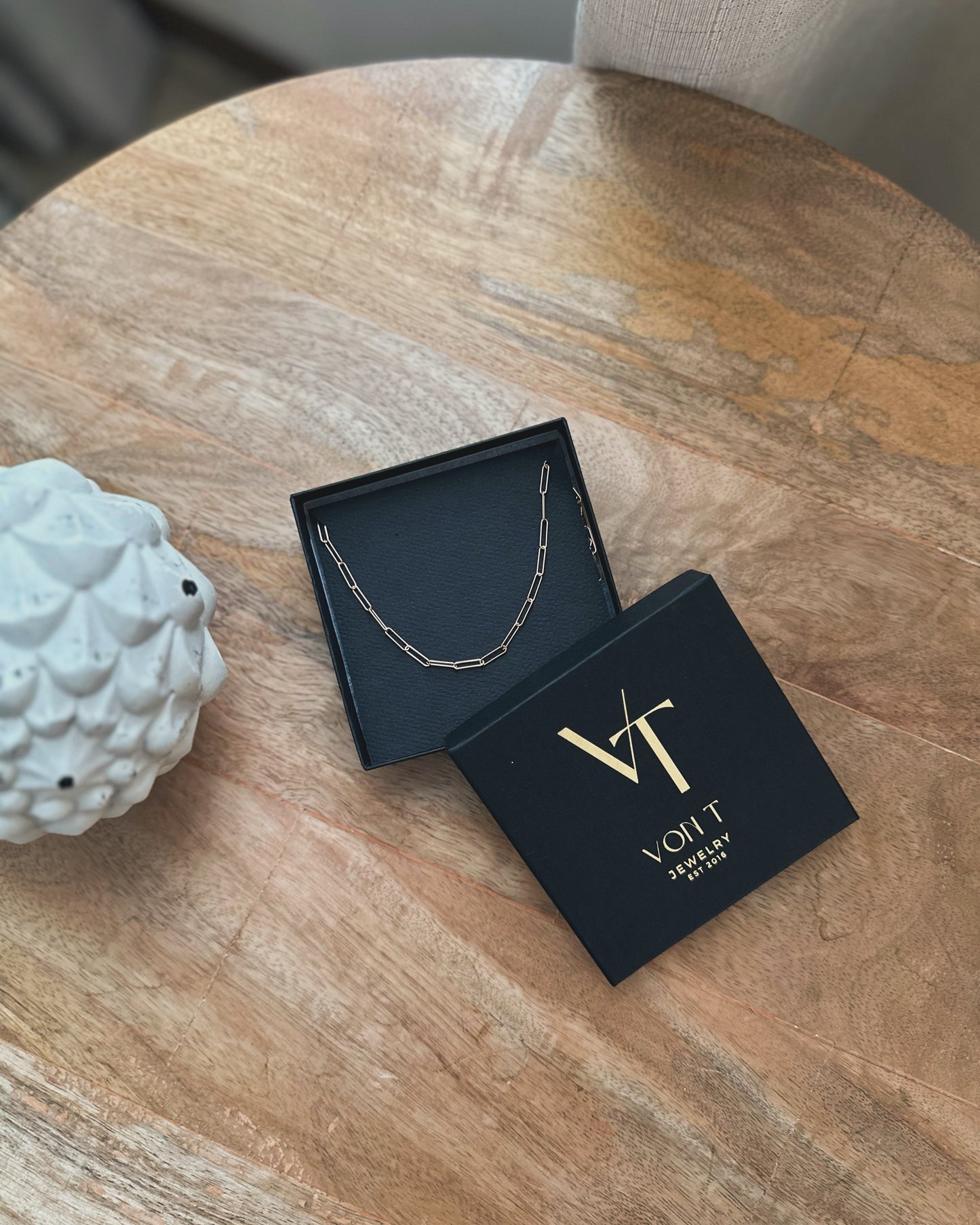 Paperclip chain necklace shown in Von T Jewelry box