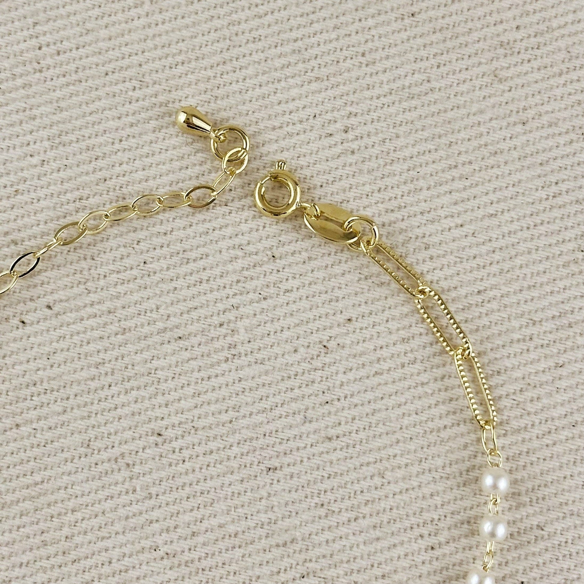 adjustable pearl and paperclip bracelet with extender chain detail and clasp