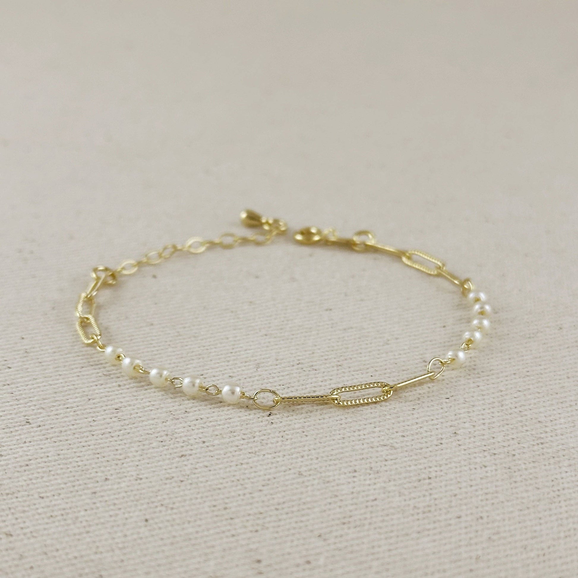 minimalist pearl and paperclip chain bracelet flat lay jewelry styling