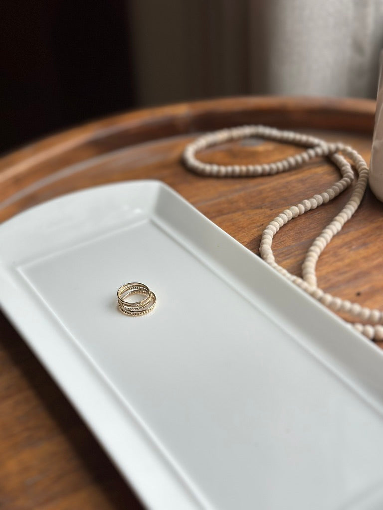 ring stack featuring the gold facet ring band on a white styled tray