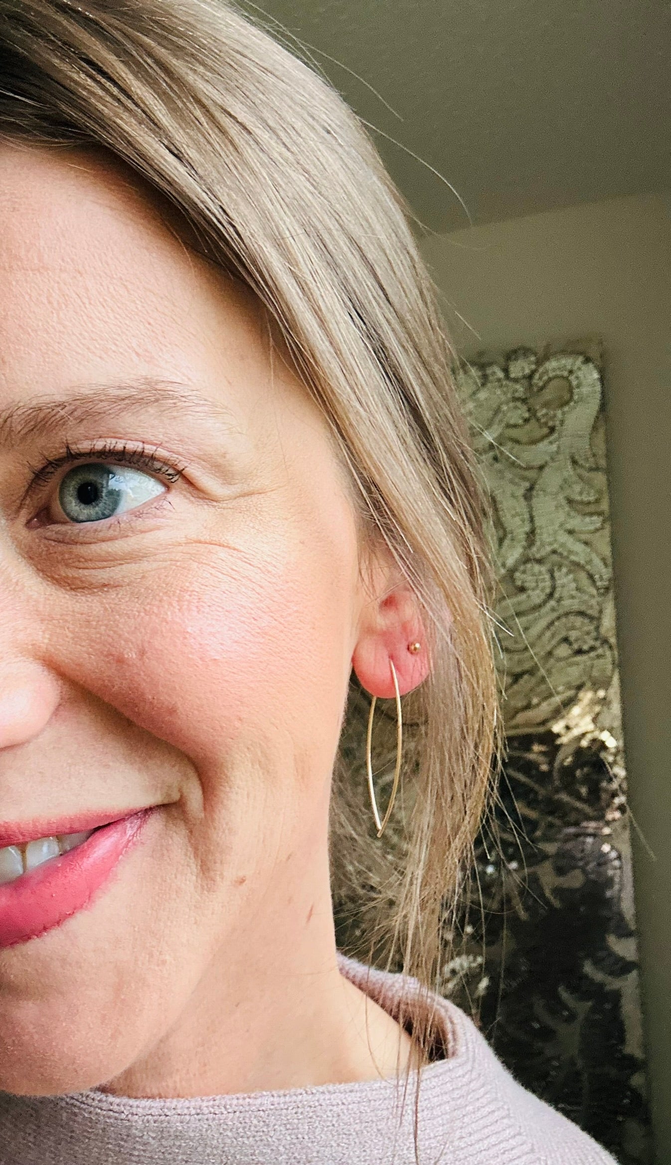 Wire threader earrings in gold on woman's ears