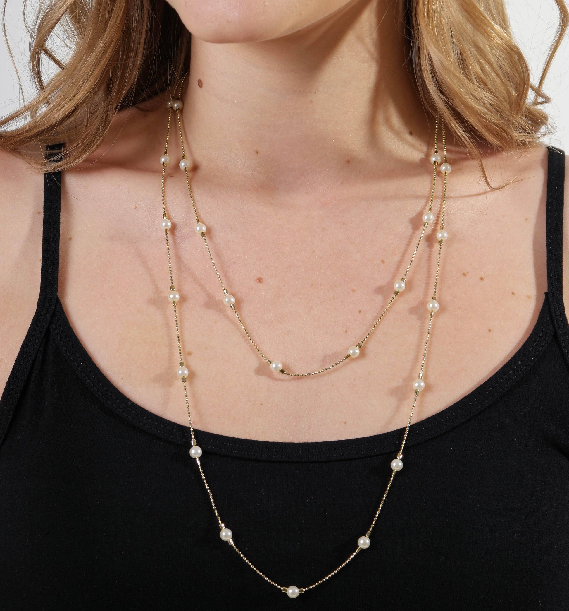 Woman wearing 18k gold filled long wrap around pearl necklace