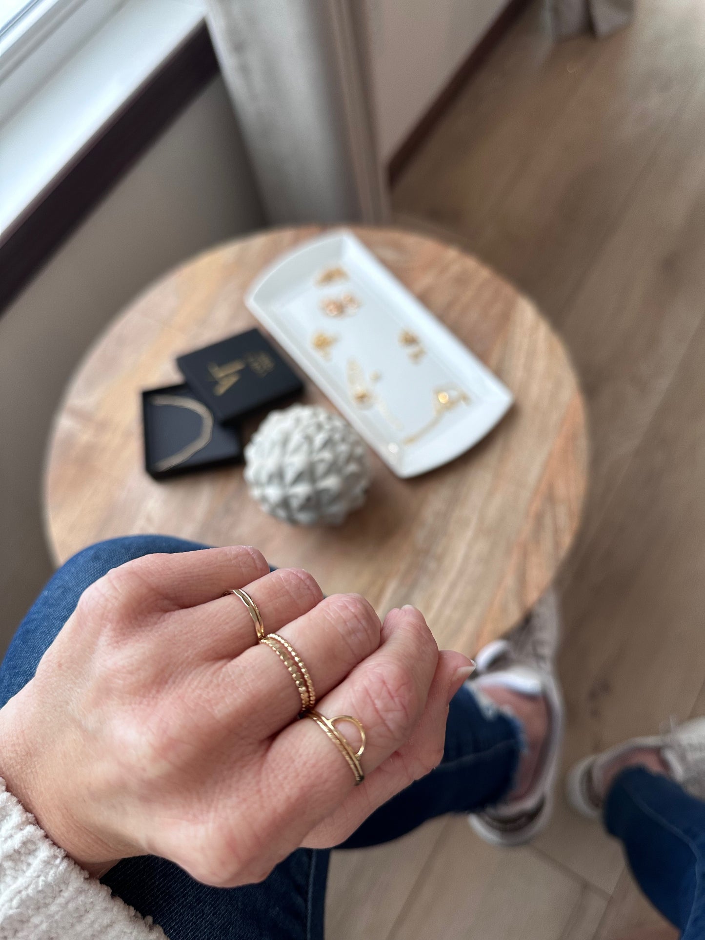 Woman's hand showing facet ring band in gold