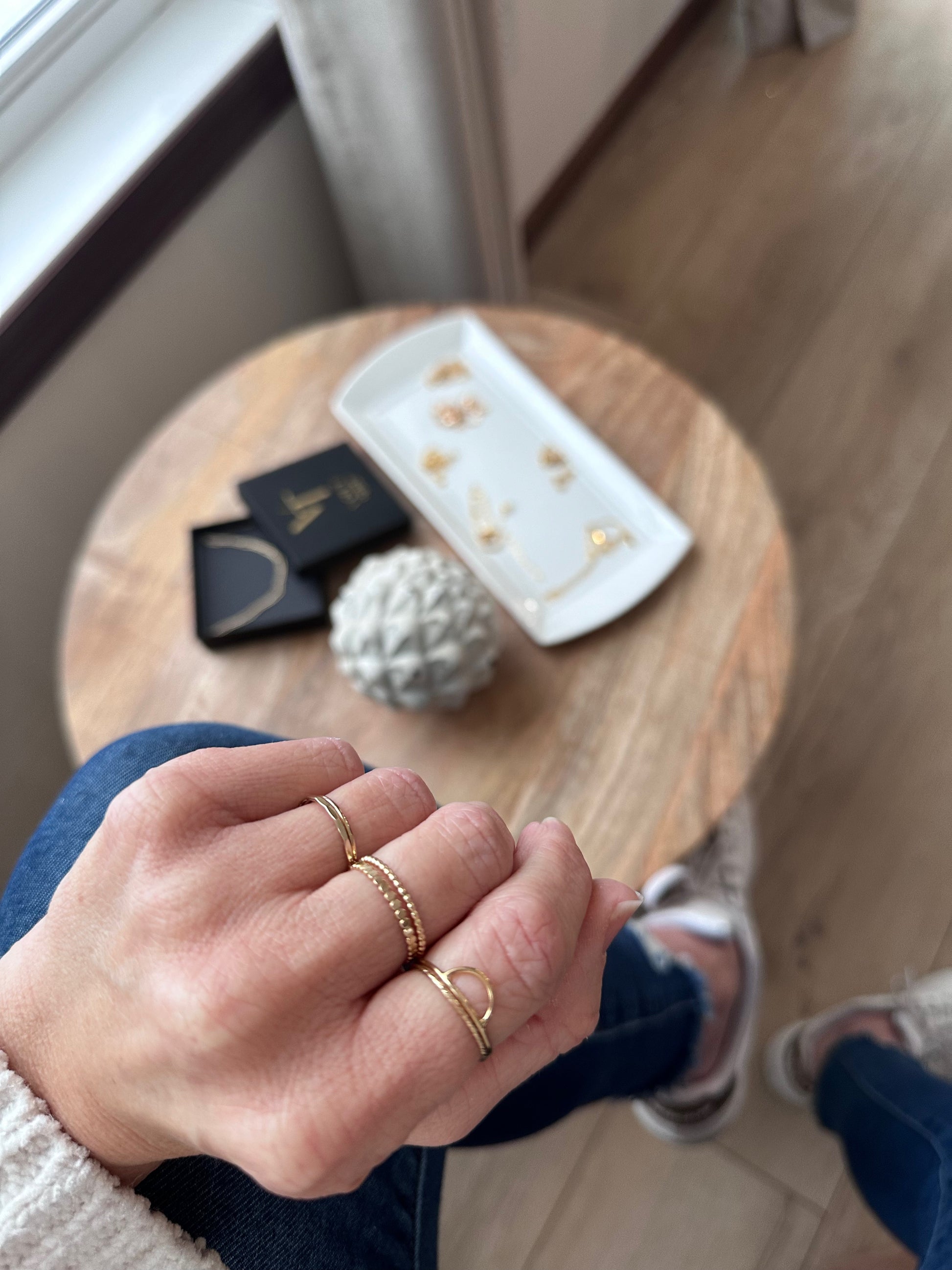 Woman's hand showing facet ring band in gold